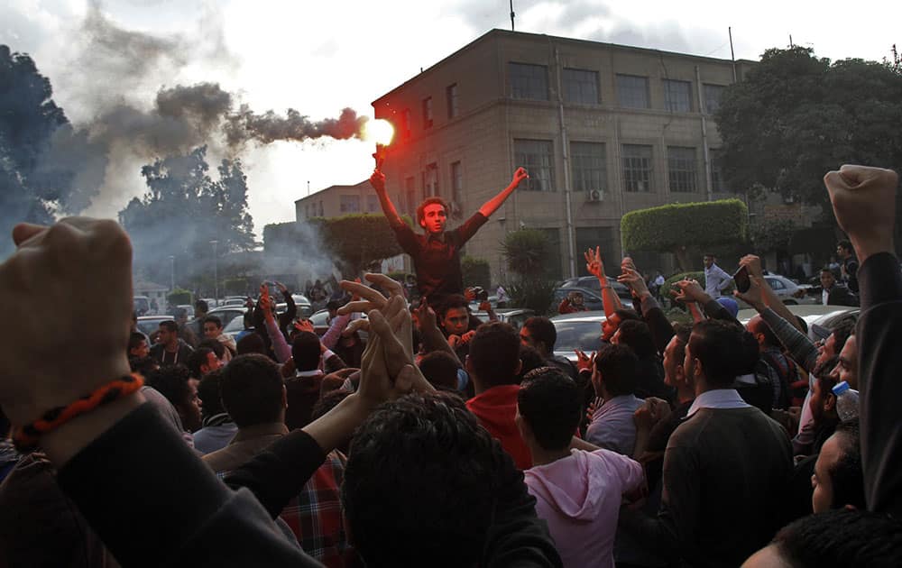 Students protest against the dismissal of the murder case against toppled President Hosni Mubarak over the killing of protesters during Egypt’s 2011 uprising, at Cairo University, Cairo, Egypt.
