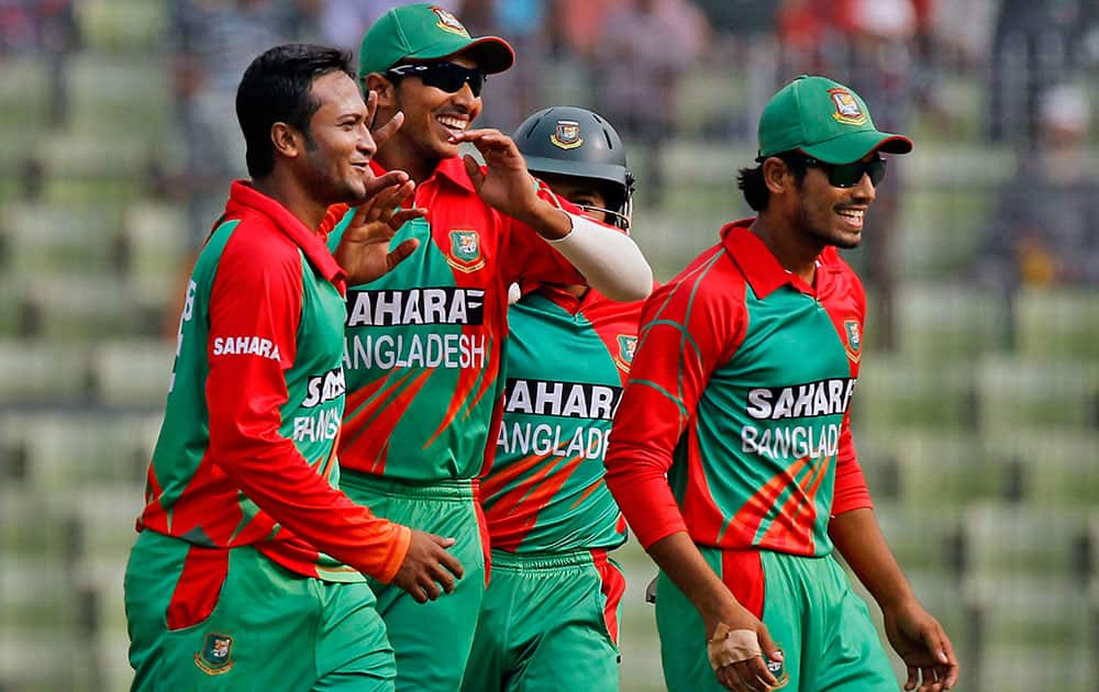 Bangladesh's Shakib Al Hasan, left, celebrates with teammates the dismissal of Zimbabwe's Brendan Taylor during the fifth one day international cricket match between them in Dhaka, Bangladesh.