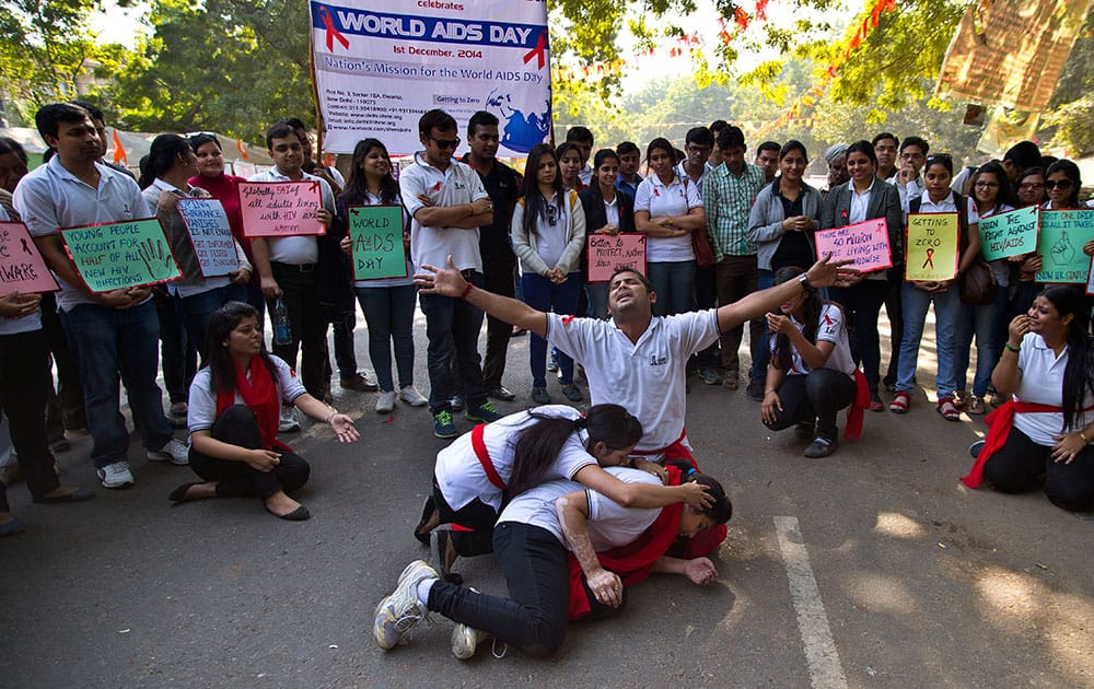 Students prepare a street play to create awareness of the dangers of HIV infections and ways to prevent it on the occasion of World AIDS Day in New Delhi, India.