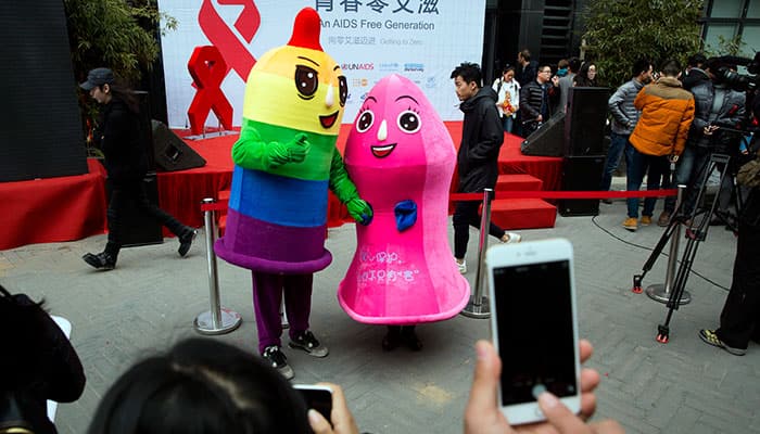 Condom mascots pose for photos at an event to promote awareness of HIV testing ahead of the Dec 1 World AIDS day in Beijing.
