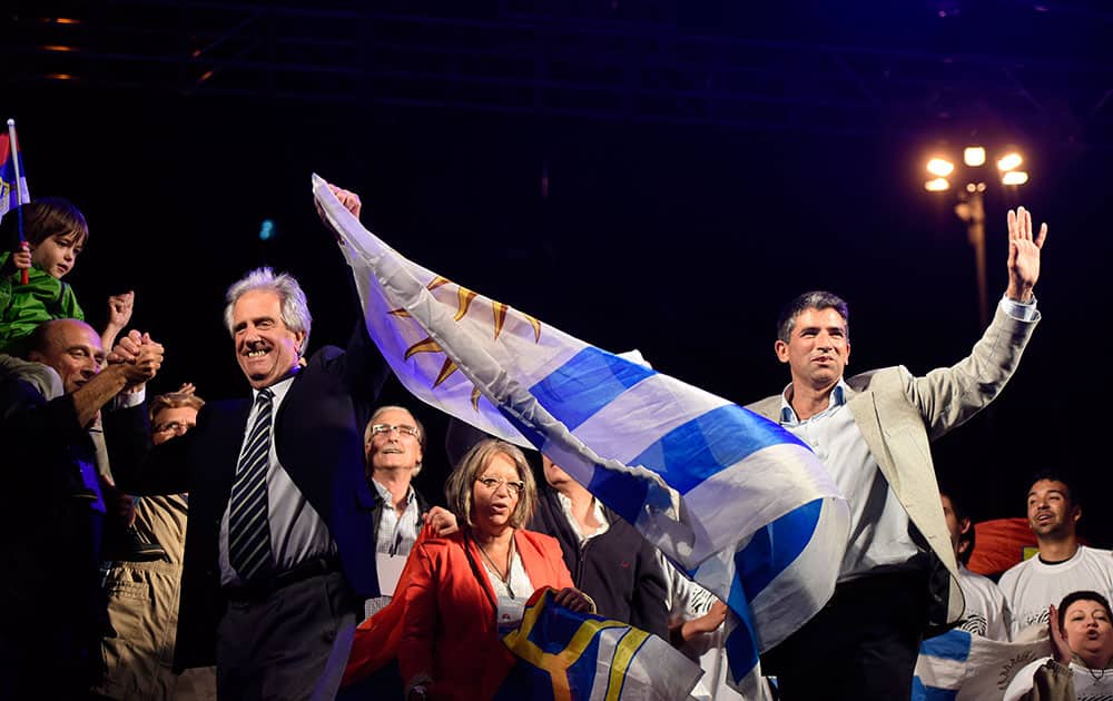 President elect Tabare Vazquez and Vice President elect Raul Sendic wave to followers while they celebrate their vicotory in Montevideo, Uruguay.