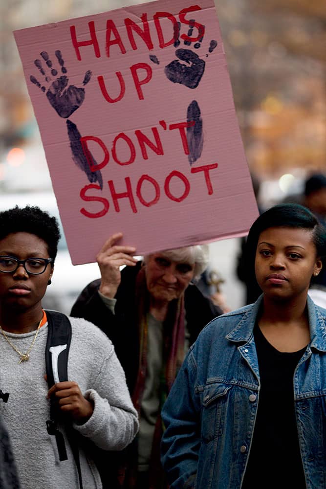 Demonstrators protest against the shooting death of unarmed 18-year-old Michael Brown, during a rally at the Department of Justice in Washington.