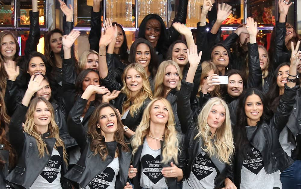 Victoria's Secret models, front row Behati Prinsloo, Alessandra Ambrosio, Candice Swanepoel, Lindsay Ellingson and Adriana Lima pose with other Victoria's Secret models for photographers a day ahead of the Victoria's Secret Fashion show, outside the store in London.