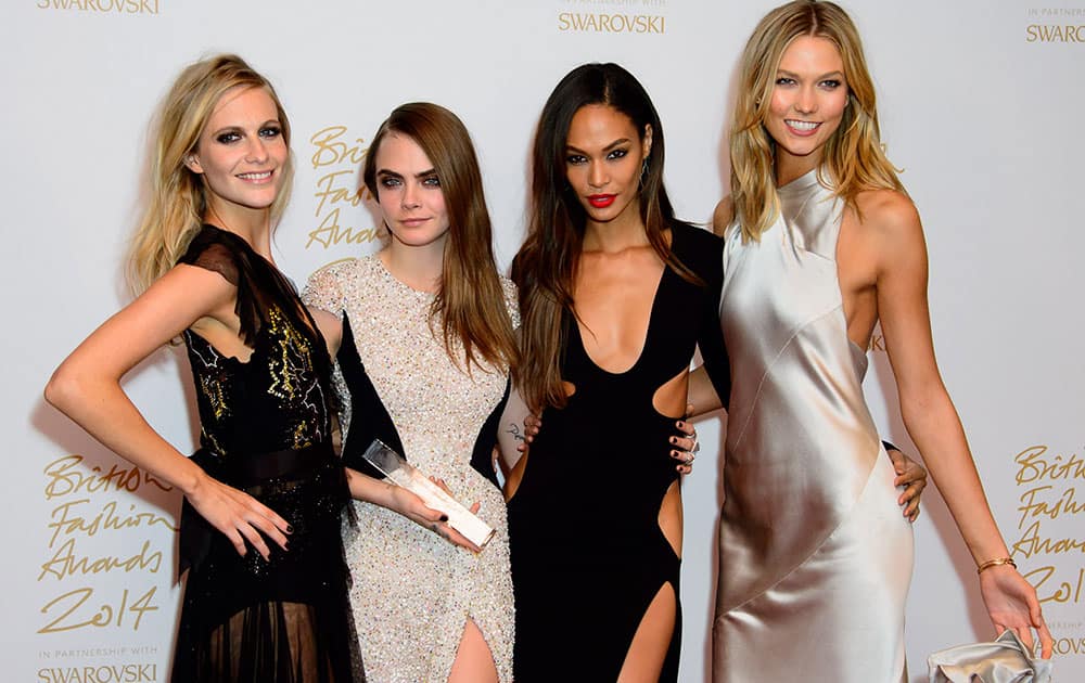 Models Poppy Delevigne, Cara Delevigne, Joan Smalls and Karlie Kloss pose for photographers with her Model of the year award at The British Fashion Awards 2014, in London.