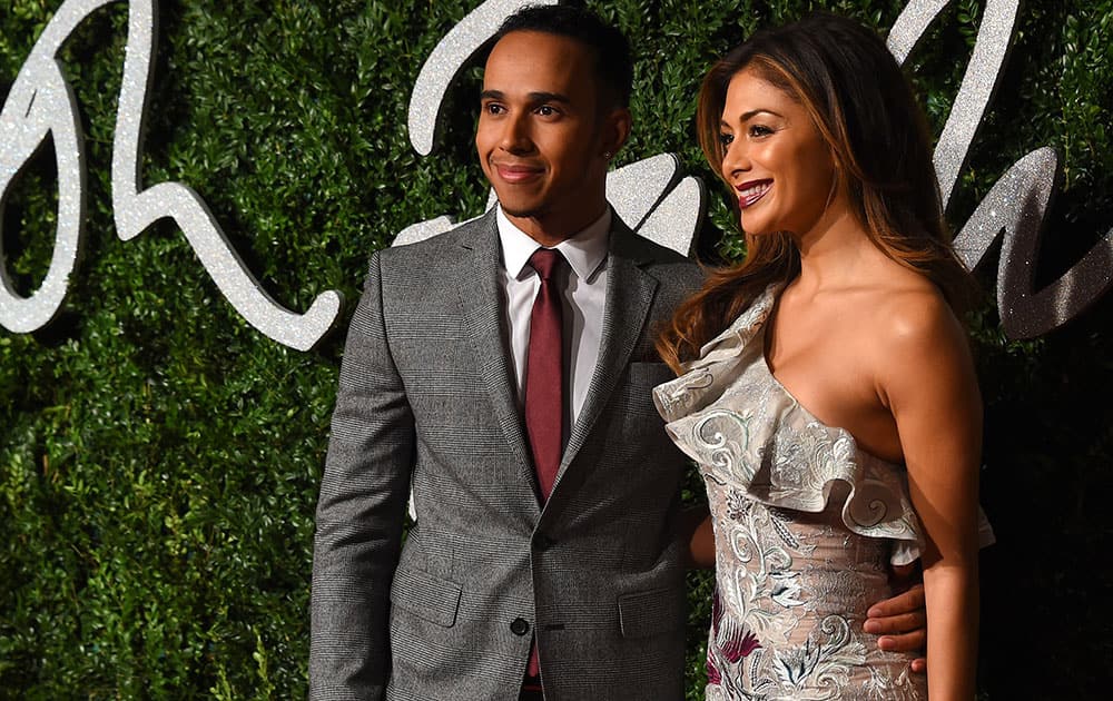 Racing driver Lewis Hamilton and singer Nicole Scherzinger pose for photographers upon arrival at The British Fashion Awards 2014, in London.