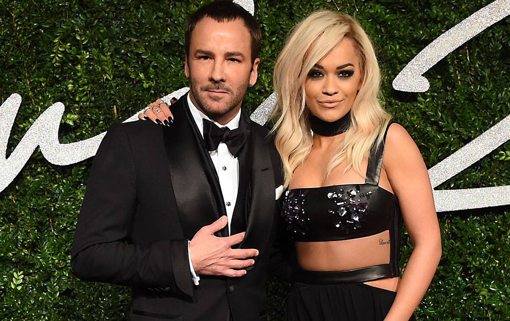 Designer Tom Ford and singer Rita Ora pose for photographers upon arrival at The British Fashion Awards 2014, in London.