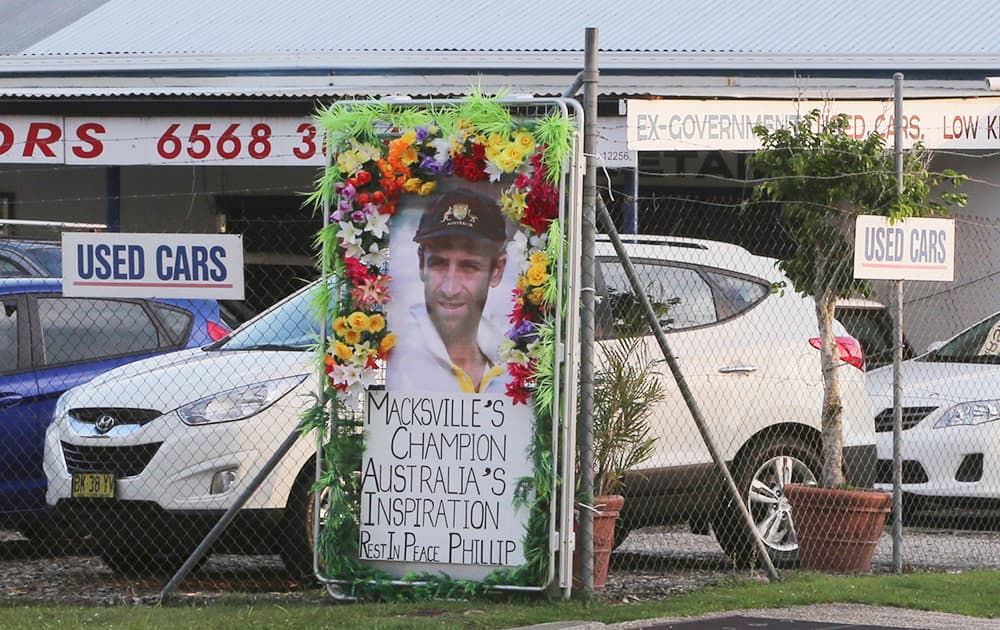 A tribute banner is attached on a fence of an auto dealership in the hometown of Australian cricket player Phillip Hughes in Macksville, Australia.