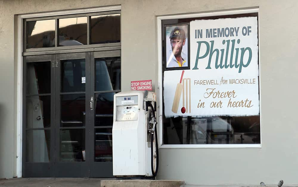 A tribute banner of the late Australian cricket player Phil Hughes, is placed on a window of a building in his home town, Macksville, Australia.