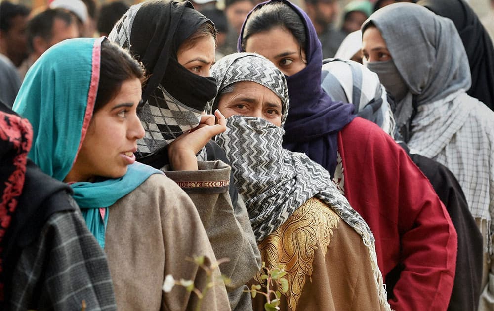 Voters wait to cast their votes for Assembly elections at a polling station in Handwara district of Jammu and Kashmir on Tuesday. 18 assembly segments went to polling in the second phase of elections in the state.