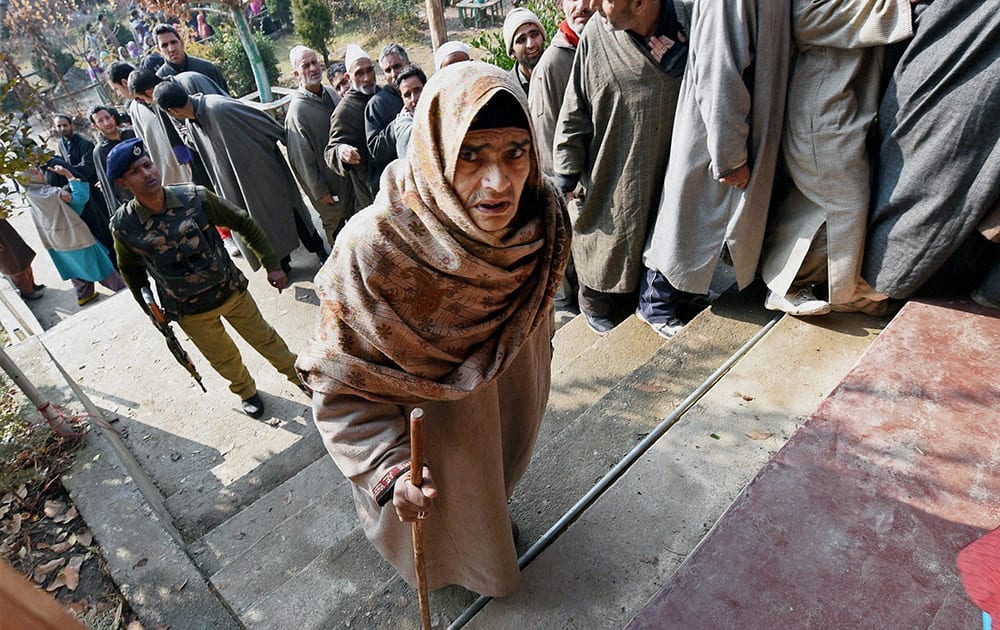 An elderly women entering a polling station to cast her vote for Assembly elections in Handwara district of Jammu and Kashmir on Tuesday. 18 assembly segments went to polling in the second phase of elections in the state.