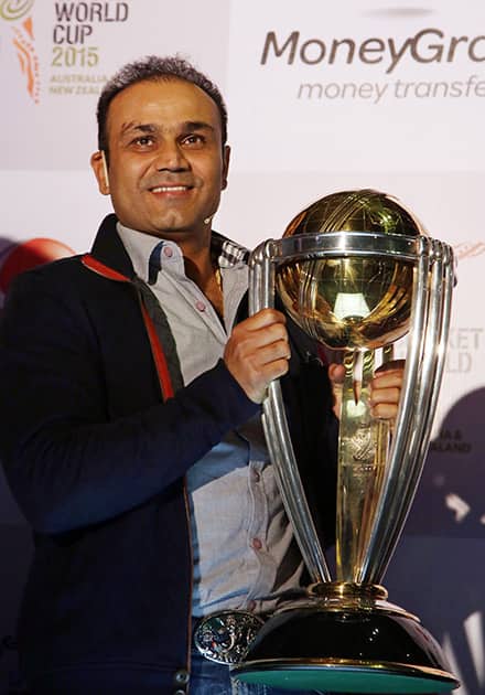 Virender Sehwag holds the ICC World Cup trophy after its arrival in the country as part of its visit to competing countries, in Mumbai.