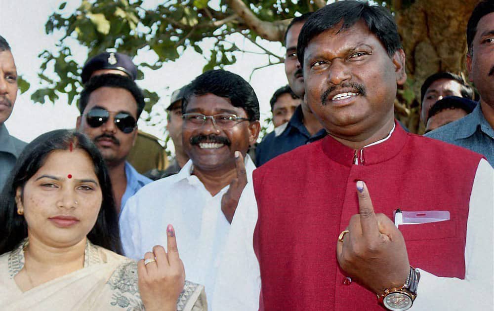 BJP leader and former CM Arjun Munda along with his wife Meera Munda show their inked fingers after casting their votes at a polling station during second phase of Jharkhand Assembly elections in Saraikela Kharsawan, Jharkhand.