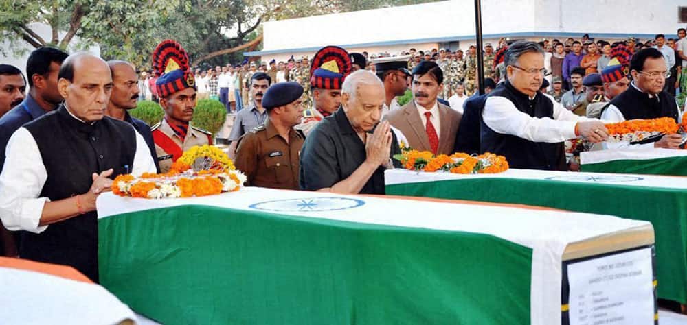 Home Minister Rajnath Singh (L) with Chhattisgarh CM Raman Singh pays his last respects to the deceased CRPF personnel in Raipur.