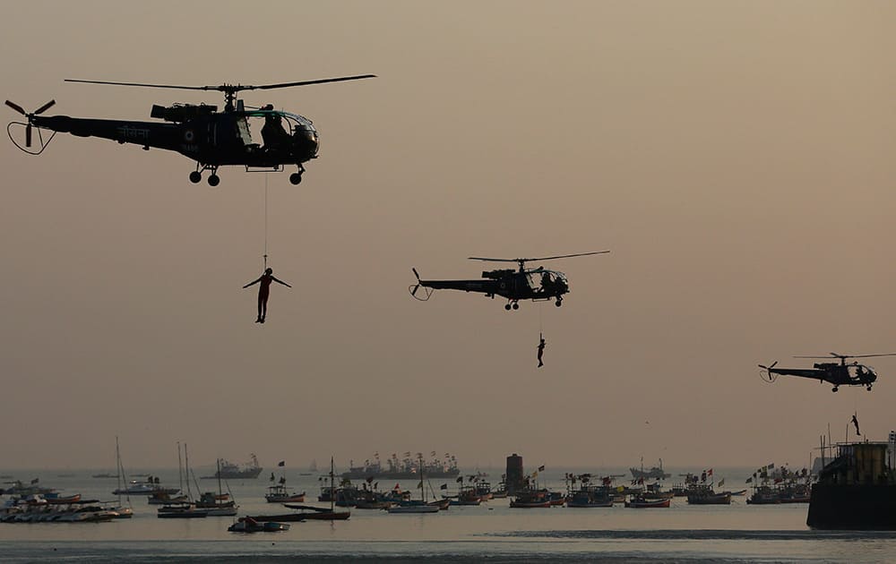 Indian Navy Commando perform skills during Naval Day celebrations at the Arabian Sea in Mumbai.