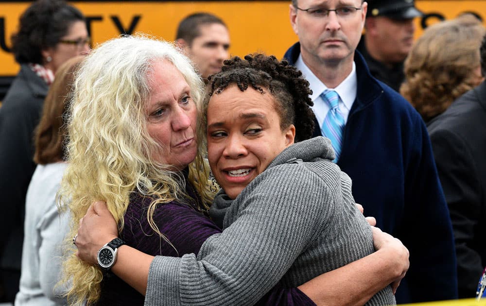 Clovis Stair, left, supervisor of Knox County School psychology, consoles Sunnyview Primary School Principal Sydney Upton near the scene where two school buses serving Chilhowee Intermediate School and Sunnyview Primary School crashed in Knoxville, Tenn.