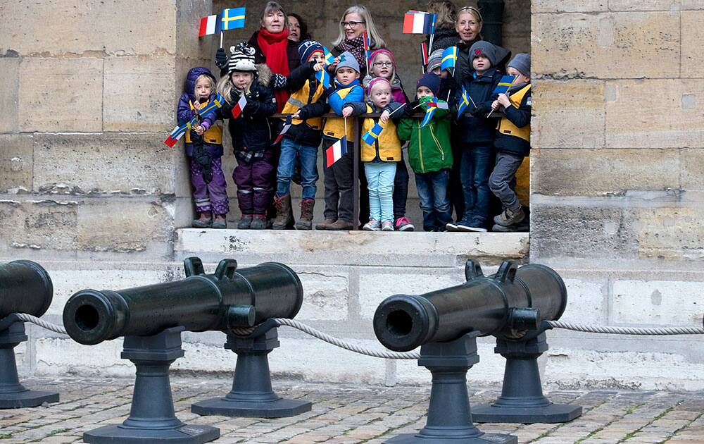 School children of the Paris Swedish school attend a military ceremony with Sweden's King Carl XVI Gustaf and Queen Silvia at the Invalides in Paris.