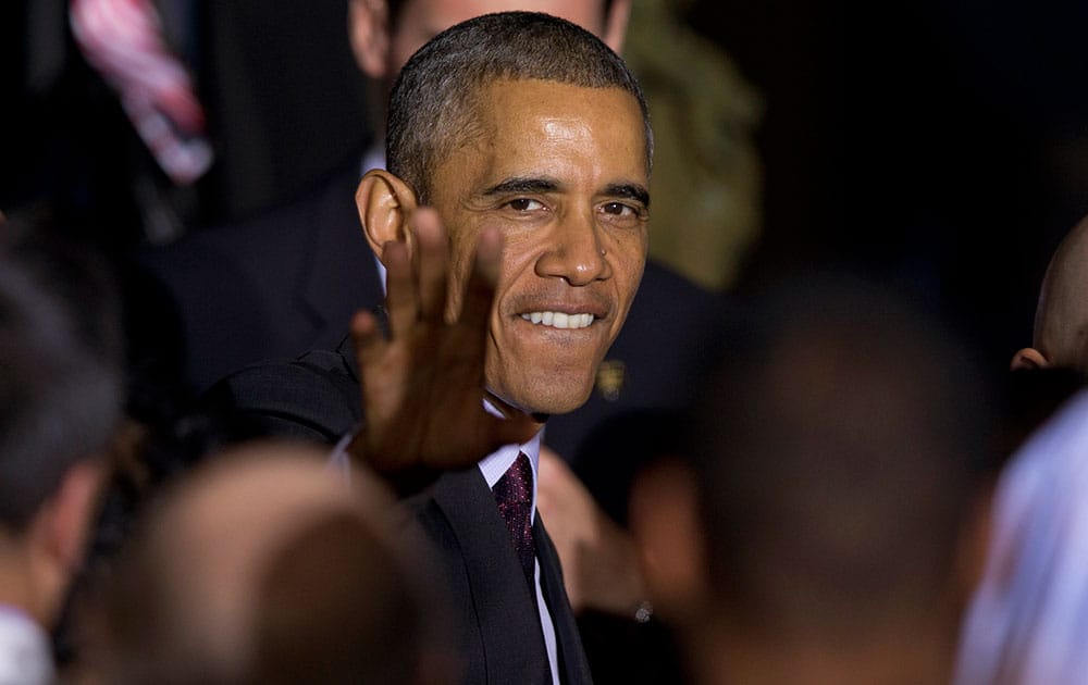 President Barack Obama greets people in the audience after speaking at the National Institutes of Health in Bethesda, Md., about the fight against Ebola.