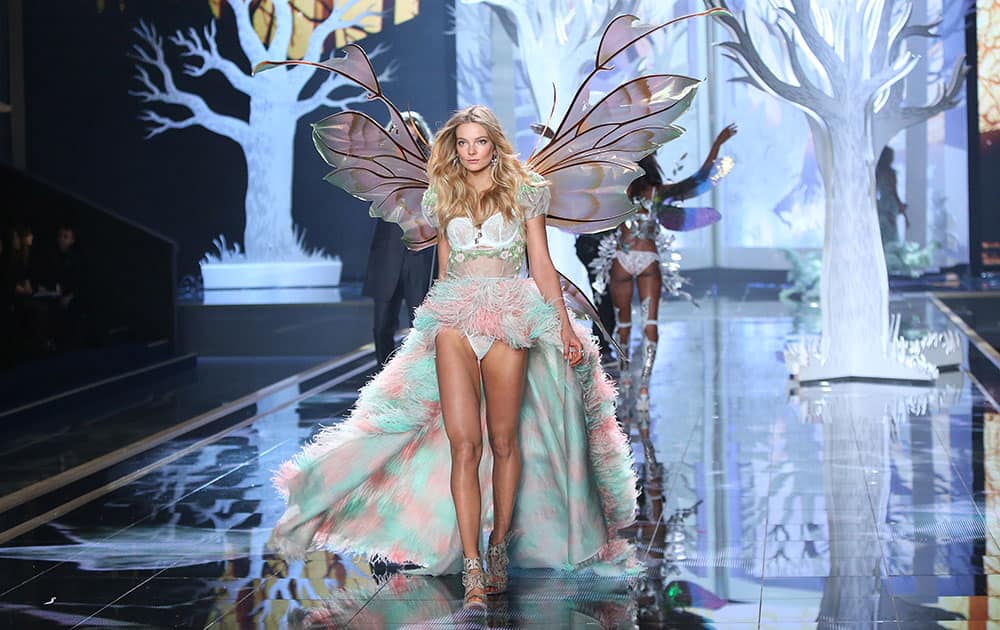 Model Eniko Mihalik walks the runway as singer Hozier performs at the Victoria's Secret fashion show in London.