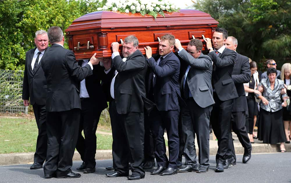 Pall bearers carry the coffin of Australian cricketer Phillip Hughes to the hearse during his funeral in Macksville, Australia.