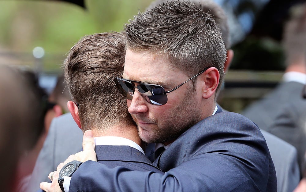 Australian cricket captain Michael Clarke, embraces a team mate during the funeral of Australian cricketer Phillip Hughes in Macksville, Australia.