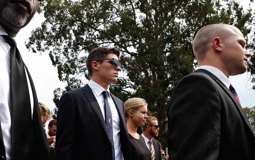 New South Wales cricketer Sean Abbott, walks along the procession during the funeral service for Phillip Hughes in Macksville, Australia.