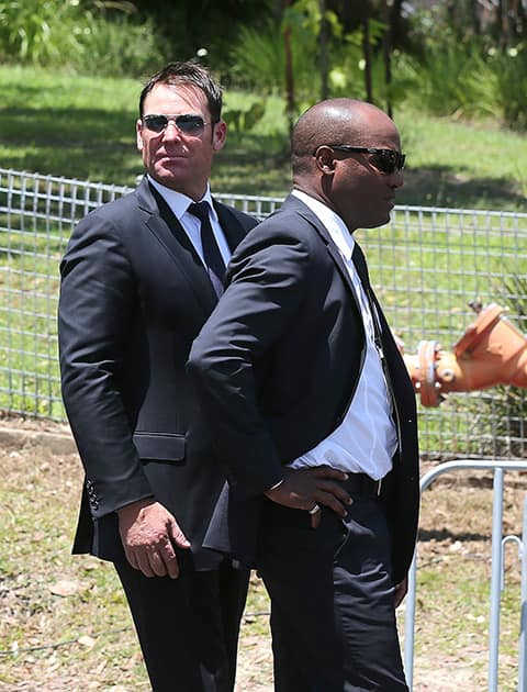 Former Australian cricketer Shane Warne and West Indies cricketer Brian Lara arrives for the funeral of Australian cricketer Phil Hughes in Macksville, Australia.