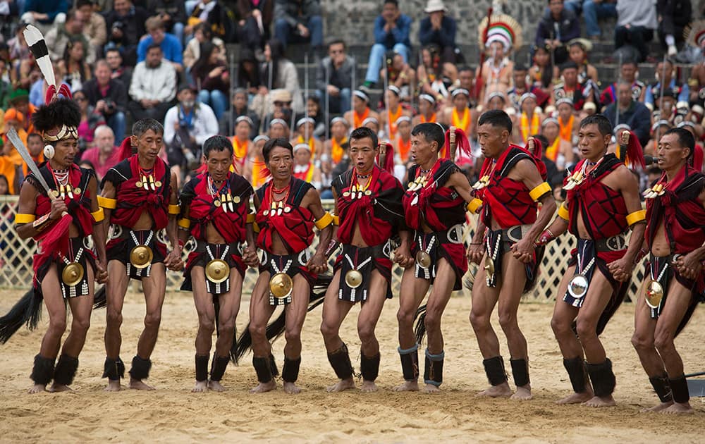 Naga tribal men in traditional attire perform a folk dance during the Hornbill festival at Kisama village in the northeastern Indian state of Nagaland.