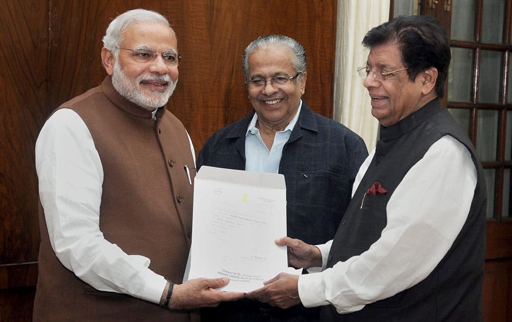 Member of Parliament and President of the Indian Union Muslim League, E. Ahamed presenting a cheque for Rs 25 lakh rupees to the Prime Minister, Narendra Modi towards the Prime Ministers National Relief Fund, for flood relief and rehabilitation, in New Delhi.