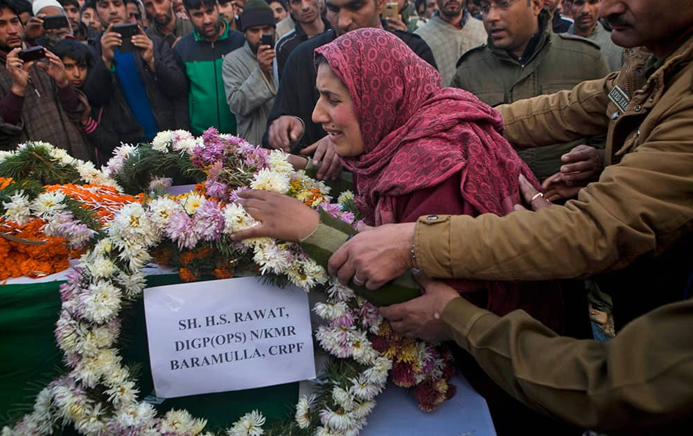 Safeena Shafi, the wife of Indian paramilitary soldier Muhammad Shafi Bhat wails as she lays the wreath on the coffin of her husband during his funeral procession in Buran, Srinagar.