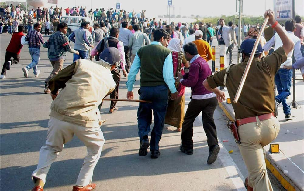 Employees of Smarak Suraksha Vahini being cane charged by the police during a protest in Gomti Nagar in Lucknow.