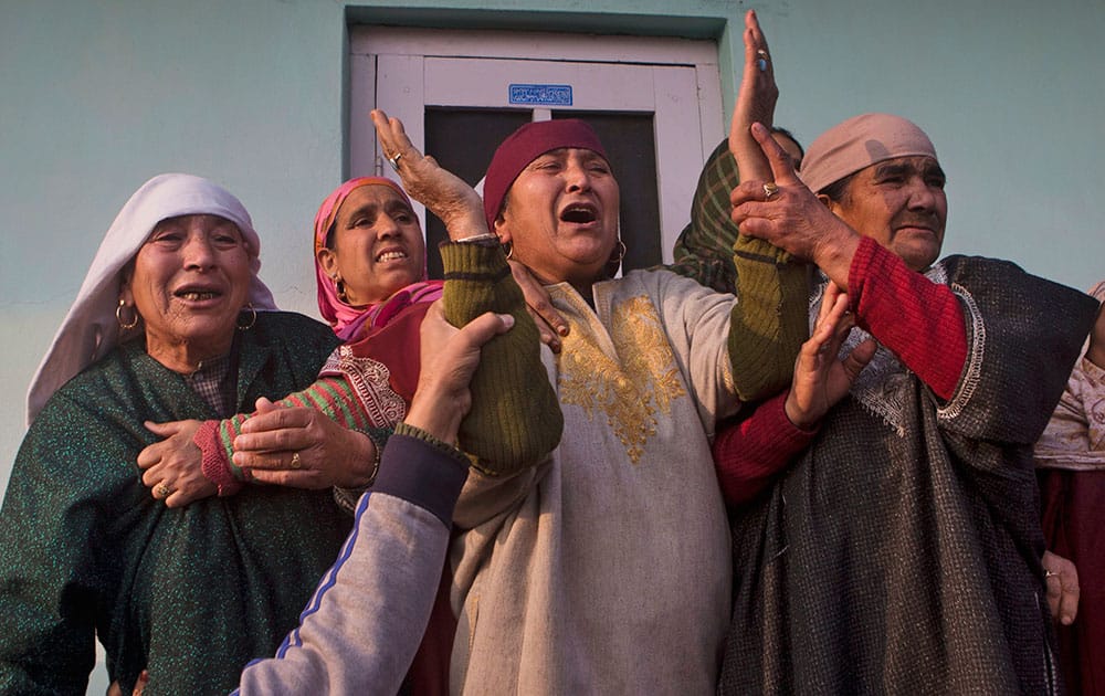 Unidentified relatives of Indian paramilitary soldier Muhammad Shafi Bhat wail during his funeral procession in Buran, some 35 kilometers (22 miles) north of Srinagar.