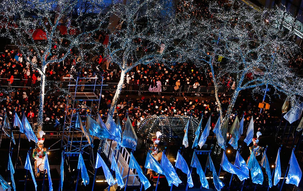 Spectators gather to watch a lighting ceremony for the Rockefeller Center Christmas tree, in New York. 