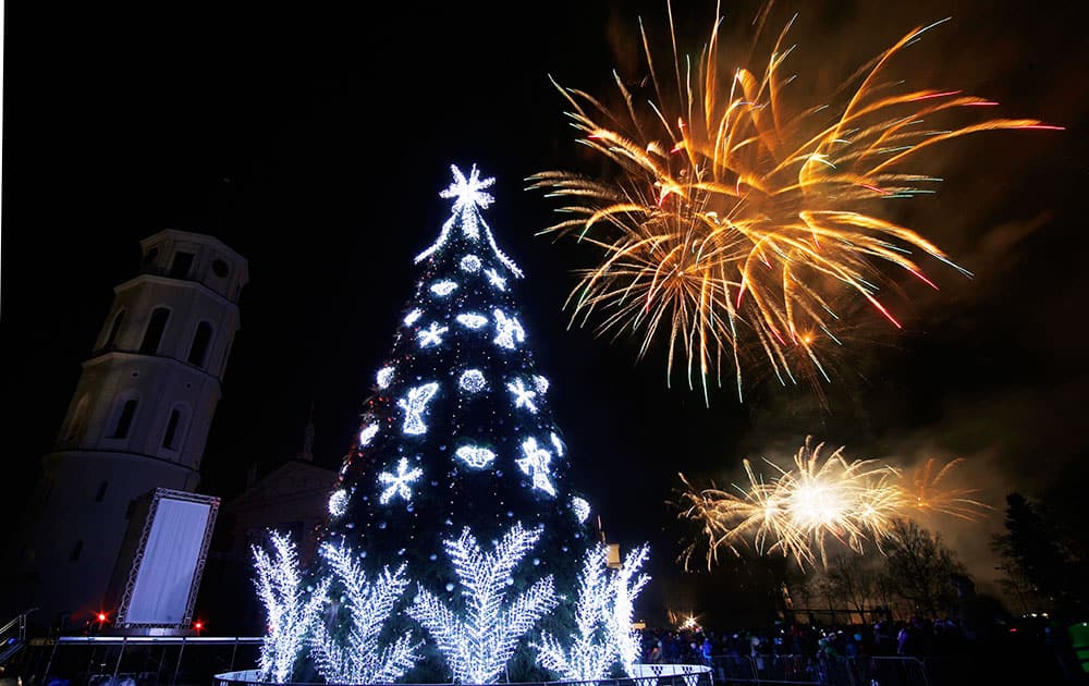 Fireworks light up the sky above at Christmas tree during a lighting ceremony at Cathedral square in Vilnius, Lithuania.