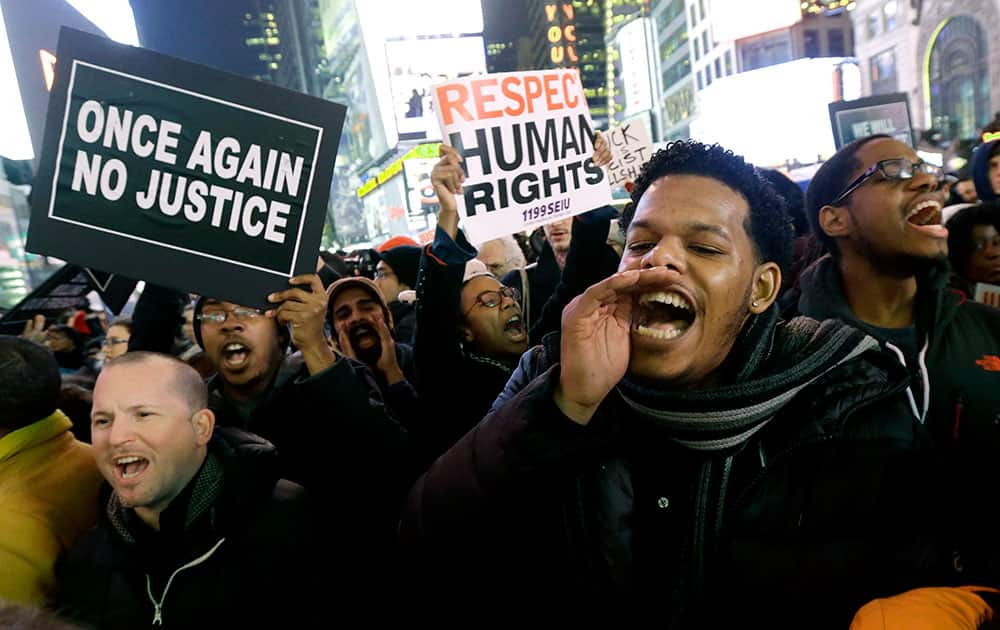 Protestors shout at Times Square after it was announced that the New York City police officer involved in the death of Eric Garner is not being indicted.