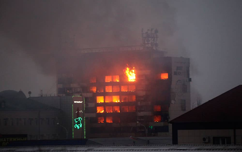 A publishing house building is seen in flames in the center of Grozny, Russia. A gun battle broke out after midnight Thursday in the capital of Russia’s North Caucasus republic of Chechnya, puncturing the patina of stability ensured by years of heavy-handed rule by a Kremlin-appointed leader. Security officials and the leader of Chechnya said gunmen traveling in several cars killed at least three traffic police officers at a checkpoint late at night in the capital of the republic, Grozny.