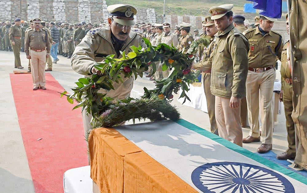 A Senior CRPF officer laying wreath at the body of ASI Shemsher Singh Yadav who was killed in a militant attack in district Pulwama.