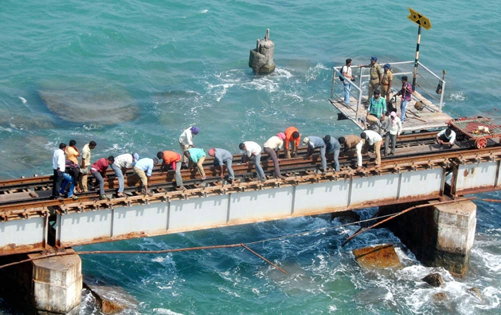 Workers repairing the railway track after a major crack was noticed by railway workers in the 100-year-old Pamban Railway bridge, in Rameswaram.