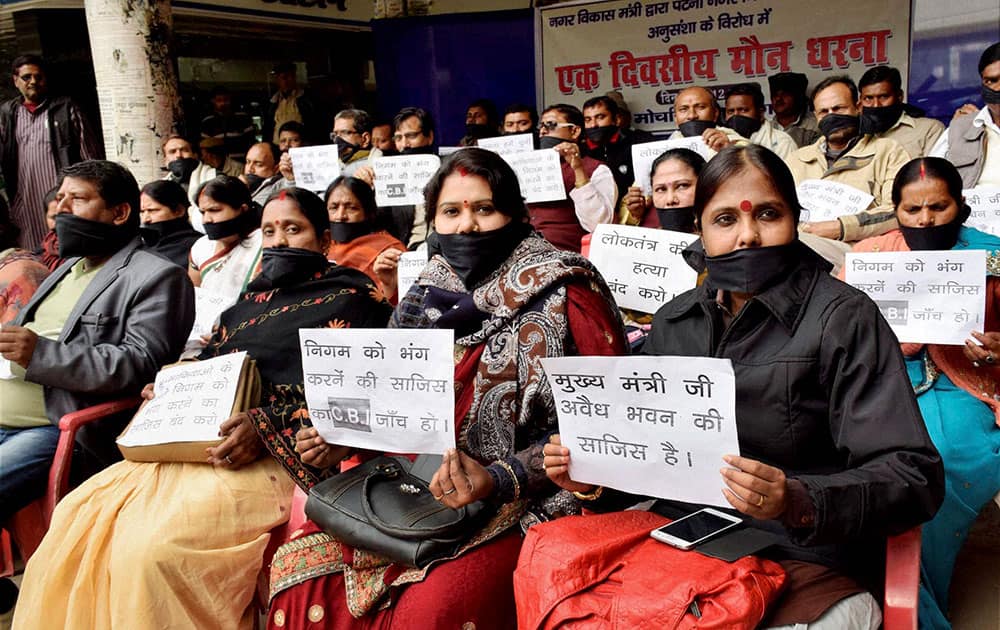 Councillors cover their mouth with black cloths during a silent protest for their demands outside Patna Municipal Corporation building in Patna.