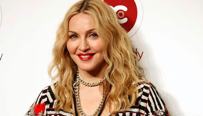 After topless coup, Madonna returns as face of Versace