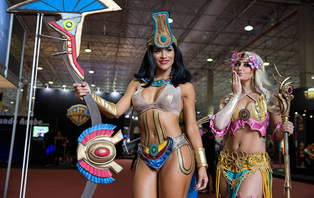 Visitors dressed as 'Smite' video game characters pose for portraits as they cosplay at the Comic Con Experience fair in Sao Paulo, Brazil.