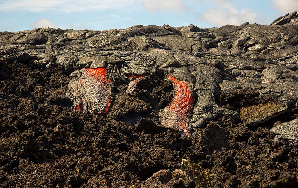 This photo released by the US Geological Survey shows a small active breakout on the upslope portion of the June 27th lava flow near the town of Pahoa on the Big Island of Hawaii.