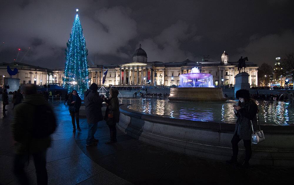 The Christmas tree shines in Trafalgar Square after the lighting ceremony in London.