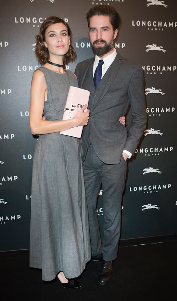 British model Alexa Chung and Jack Guinness pose at the opening of the Longchamp store in Paris, France.