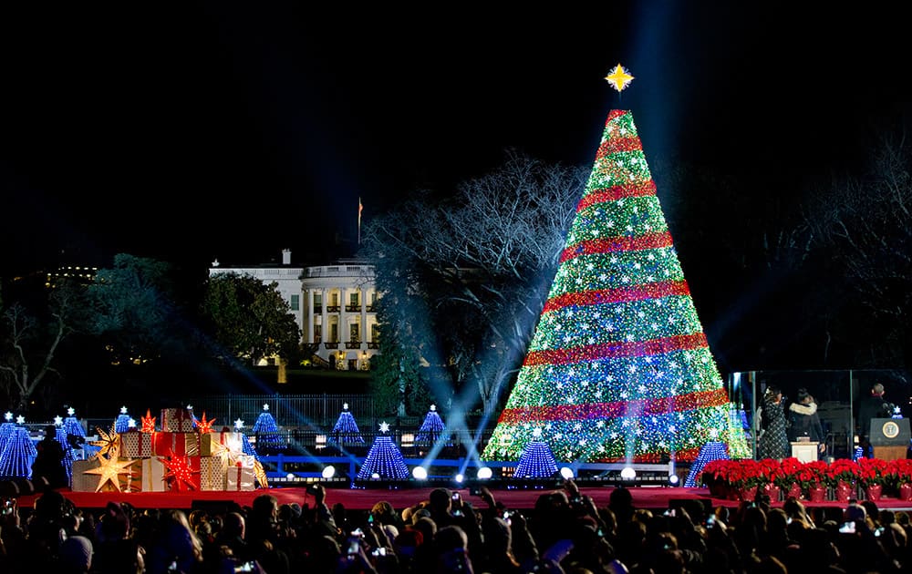 President Barack Obama and the first family stands right, after lighting the 2014 National Christmas Tree during the National Christmas Tree lighting ceremony at the Ellipse near the White House in Washington.