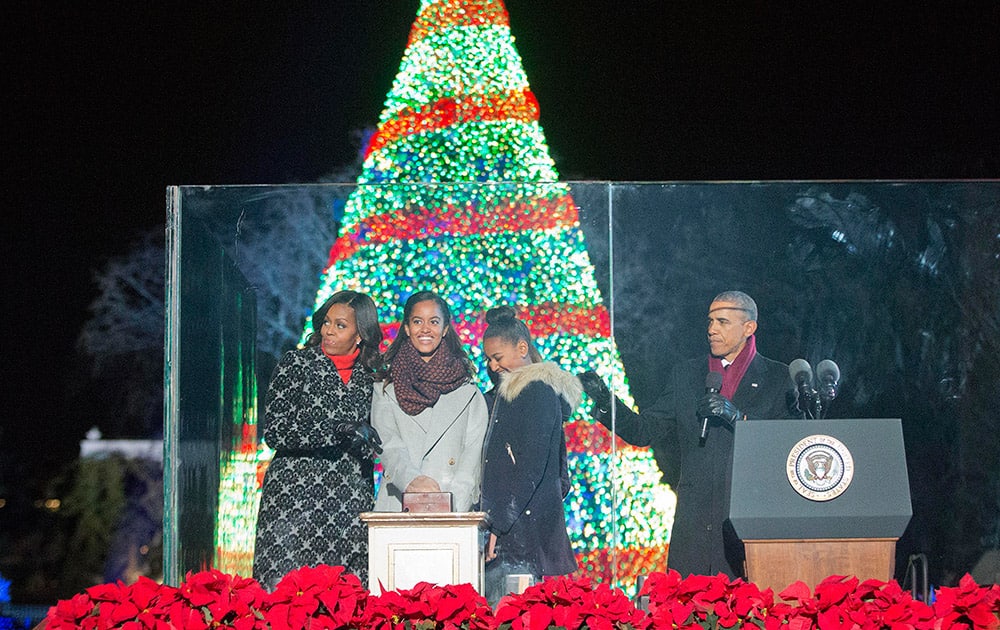 President Barack Obama  with first lady Michelle Obama and daughters Malia and Sasha, participate in the National Christmas Tree lighting ceremony.