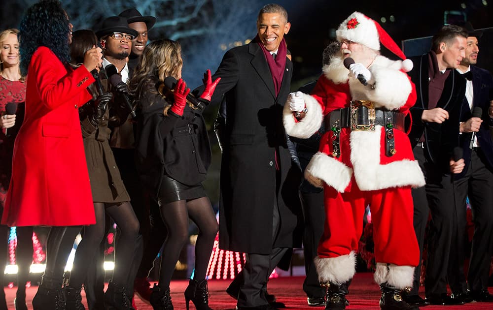 President Barack Obama, joins Santa Claus and other performers on stage during the finale at the National Christmas Tree lighting ceremony.