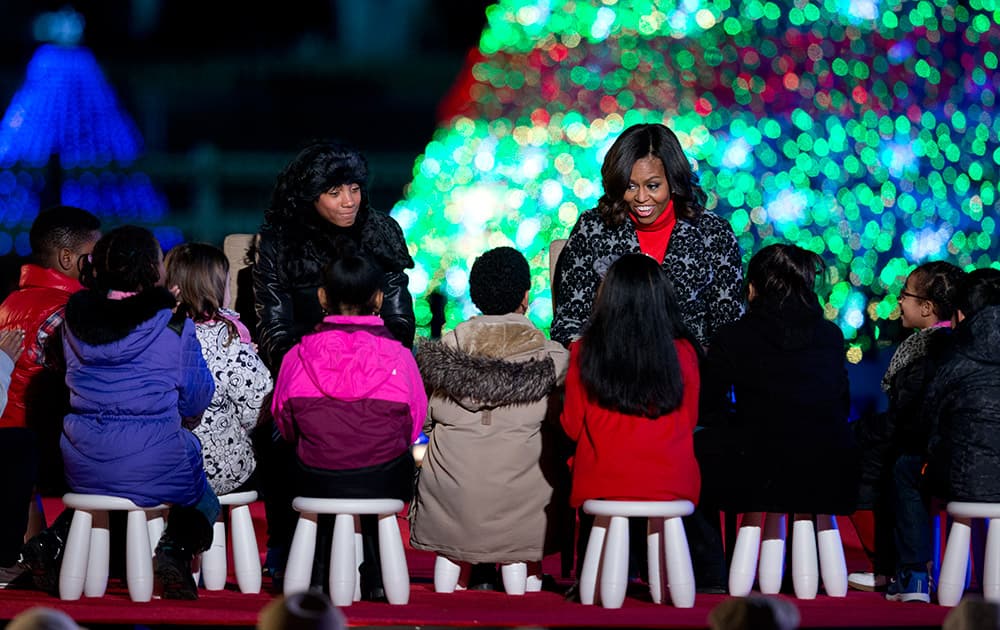 First lady Michelle Obama, right, and little league pitcher Mo'ne Davis read 'Twas The Night Before Christmas' during the National Christmas Tree lighting ceremony at the Ellipse near the White House in Washington.