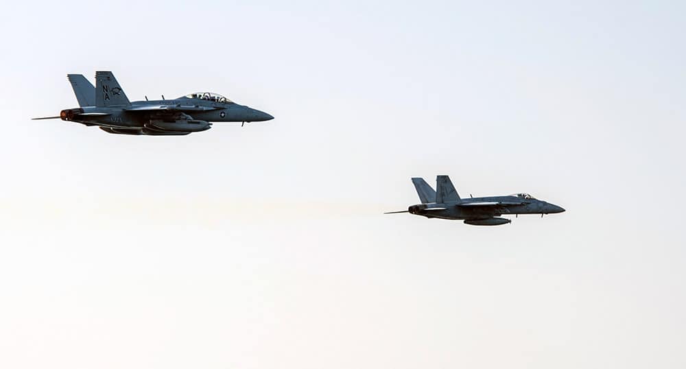 Fighter jets conduct a high speed fly-by of the Nimitz-class aircraft carrier USS Carl Vinson (CVN 70) as the ship conducts flight operations in the US 5th Fleet area of operations supporting Operation Inherent Resolve targeting Islamic State militants.