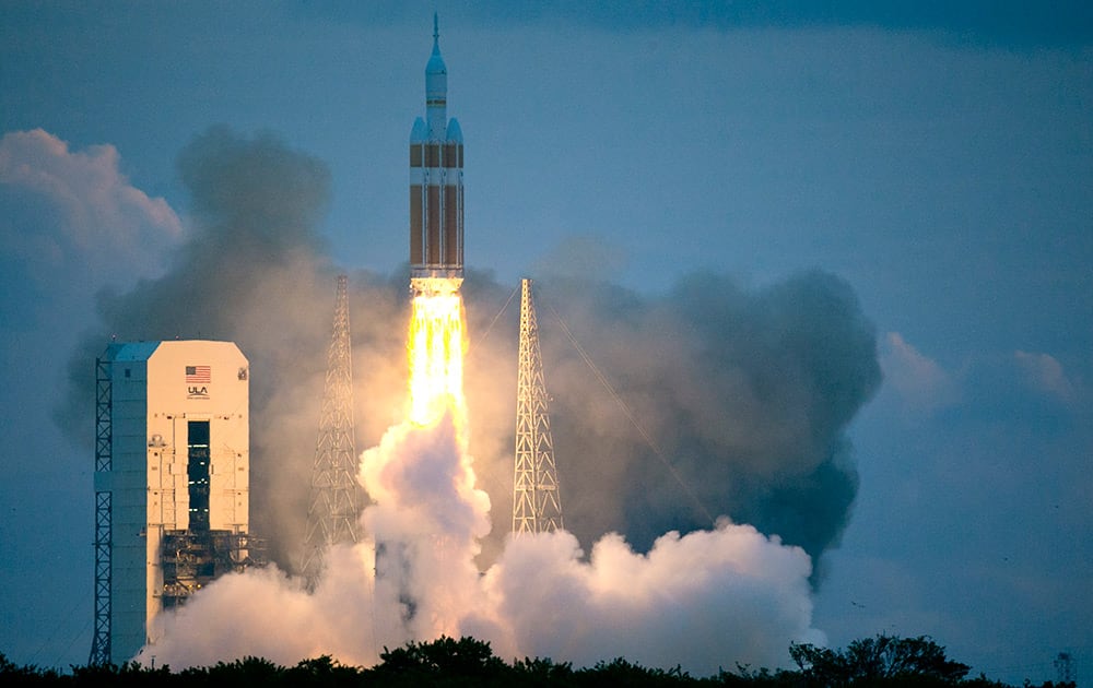 The NASA Orion space capsule atop a Delta IV rocket, in its first unmanned orbital test flight, lifts off from the Space Launch Complex 37B pad at the Cape Canaveral Air Force Station, in Cape Canaveral, Fla.