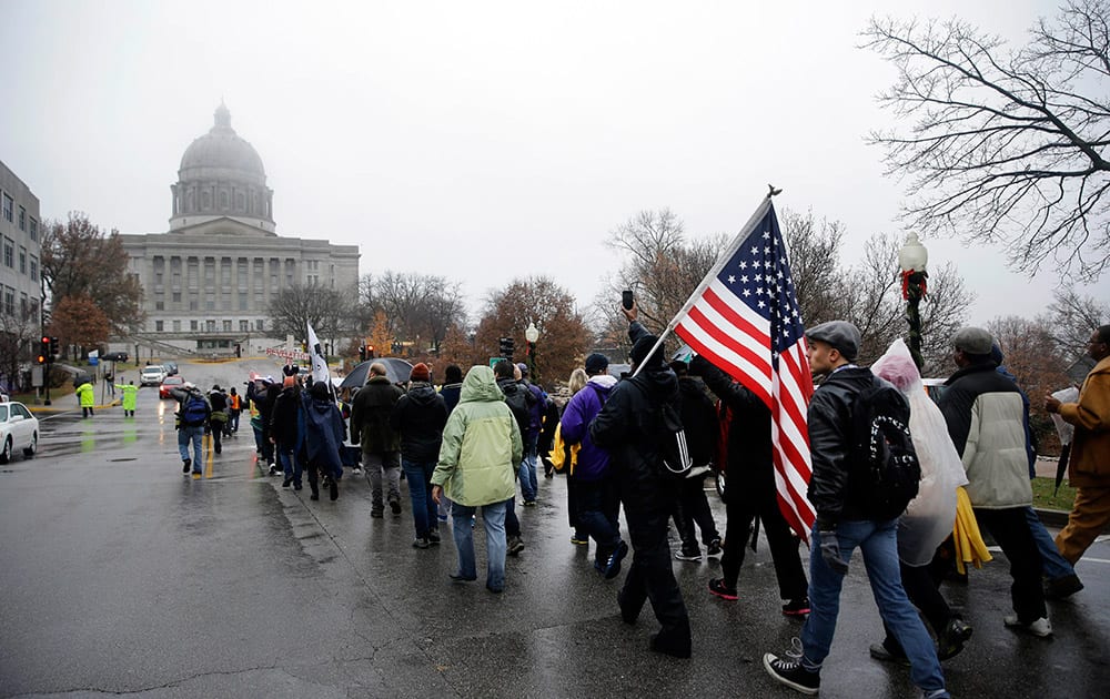 Protesters march to the final stretch to the Missouri Capitol on the last day of a 7-day march, in Jefferson City, Mo.